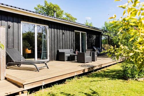 a wooden deck with chairs on top of a house at LF12257-Hjerm-Livbjerggardvej-57 in Hjerm