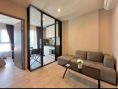 a living room with a couch and a table at The Base Pattaya Seaview Condo in Pattaya Central
