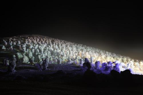a large group of people standing in the dark at 蔵王温泉 岩清水料理の宿 季の里 in Zao Onsen