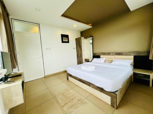 a bedroom with a large white bed in a room at Away From Home - 10 - Rooms In Ooty, Home Stay in Ooty in Ooty