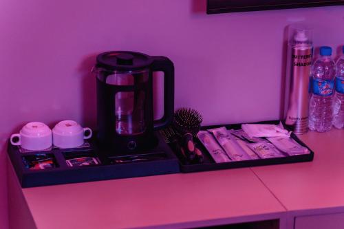 a black coffee maker sitting on top of a counter at Catba SunWoo Homestay & Hotel in Cat Ba