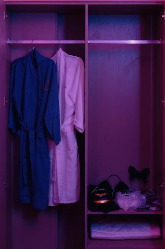 a closet filled with clothes and a blue jacket at Catba SunWoo Homestay & Hotel in Cat Ba