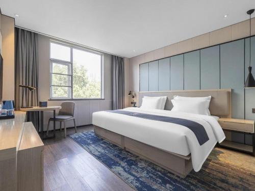 Ένα ή περισσότερα κρεβάτια σε δωμάτιο στο Echarm Hotel Jiayulongwan Peninsula