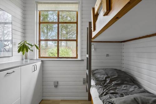 a bed in a room with a window at LF14163-Roslev-Kybehuse-3 in Roslev