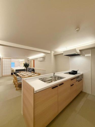 a kitchen with a sink and a living room at b hotel Miyajima Omotesando - Sacred Island Stay 21 in Miyajima