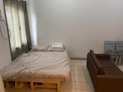 a small room with a bed and a couch at The Pahina Suite in Marilao