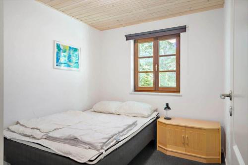a small bedroom with a bed and a window at LF11597-Struer-Plantagevej-97 in Struer