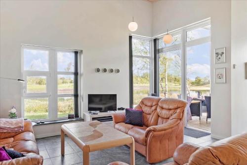 a living room with a couch and a chair at LF16231-Logstor-Marthasvej-19 in Løgstør