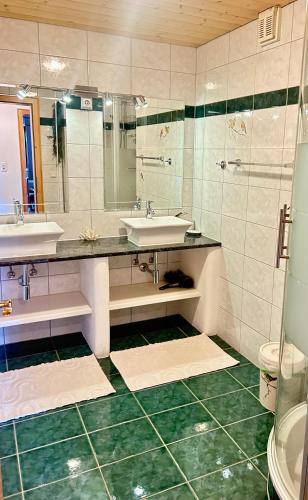 a bathroom with two sinks and a shower at Haus Susanne in Bürserberg