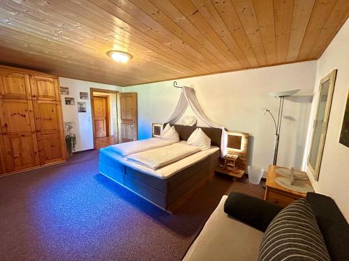 a bedroom with a bed and a couch in it at Haus Susanne in Bürserberg