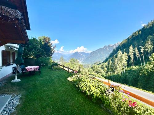 a garden with a bench and a view of the mountains at Haus Susanne in Bürserberg