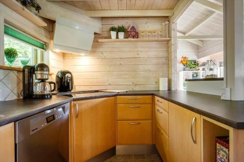 a kitchen with wooden cabinets and a counter top at LF15023-Skals-Lynderup-Strand-2 in Skals