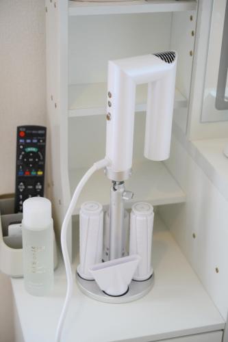 a kitchen counter with a mixer and cups on it at グッドタイム新城 in Aomori