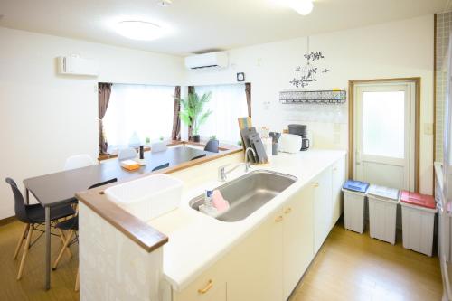 a kitchen with a sink and a counter at グッドタイム新城 in Aomori