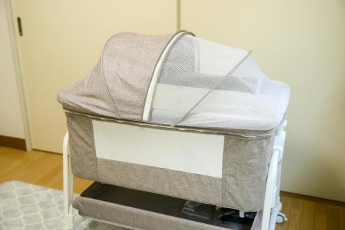 a suitcase on a cart in a room at グッドタイム新城 in Aomori