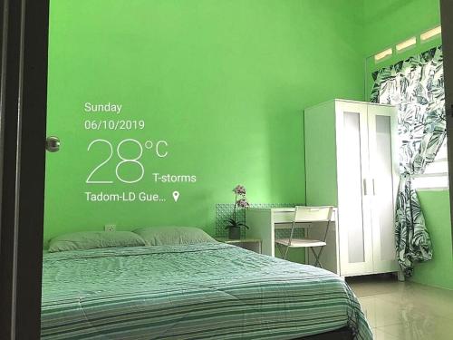 a green bedroom with a bed and a desk at KLIA Guesthouse-3 bedroom 2 bathroom in Banting