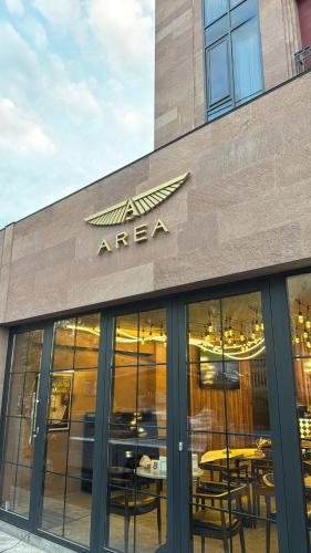 a sign on the side of a restaurant with tables at AREA Hotel Yerevan in Yerevan