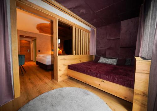 a bedroom with a bed and a large mirror at Die Seefelderin - Boutiquehotel St. Georg in Seefeld in Tirol