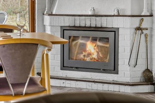 a fireplace with a fire in it in a living room at LF14301-Roslev-Vollebjergvej-1 in Roslev