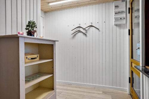 a room with a white wall and a shelf at LF14301-Roslev-Vollebjergvej-1 in Roslev