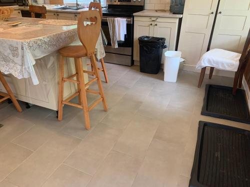 a kitchen with a tile floor with a counter at Chalet Ski Mont Calm Water Falls River Rawdon in Rawdon