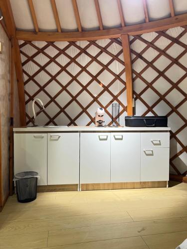 a kitchen with a white counter in a attic at Sky camp in Erdenet
