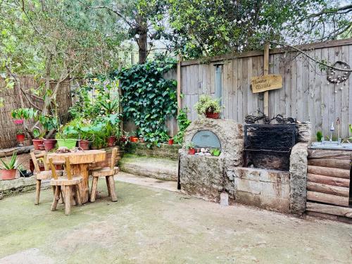 a backyard with a table and an outdoor oven at Cabaña del Bosque de Laguna Verde in Valparaíso