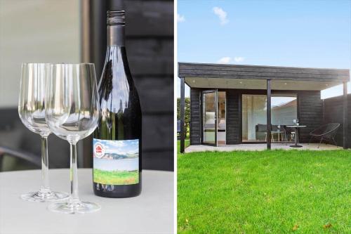 a bottle of wine sitting next to a wine glass at LF13170-Nykobing-mors-Havevej-22 in Nykøbing Mors