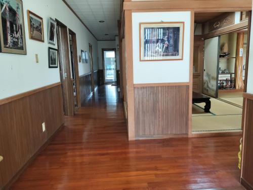 an empty hallway in a building with wood floors and paintings at Kanupata - Vacation STAY 18612 in Ishigaki Island