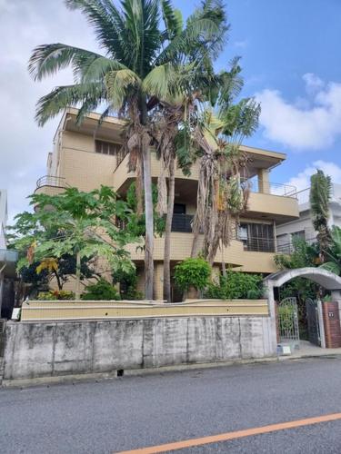 a building with palm trees in front of it at Kanupata - Vacation STAY 18612 in Ishigaki Island
