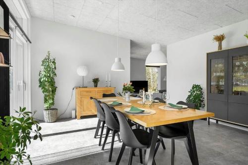 a dining room with a wooden table and chairs at LF302-Hurup-Helligsovej-2-F in Hurup