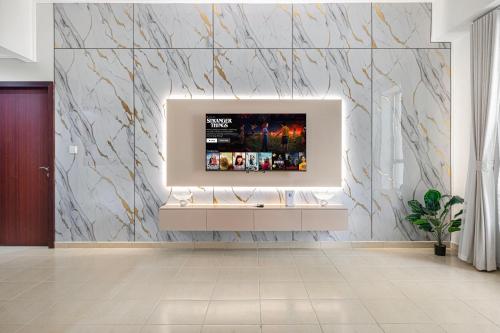 Una sala de estar con un televisor en una pared de mármol. en Luxury Residence in the Heart of JBR, en Sabkhah