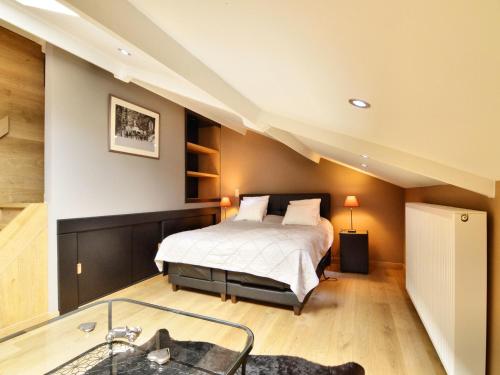 a bedroom with a bed and a bath tub at Walk Luxury Stay with Pool in Robertville