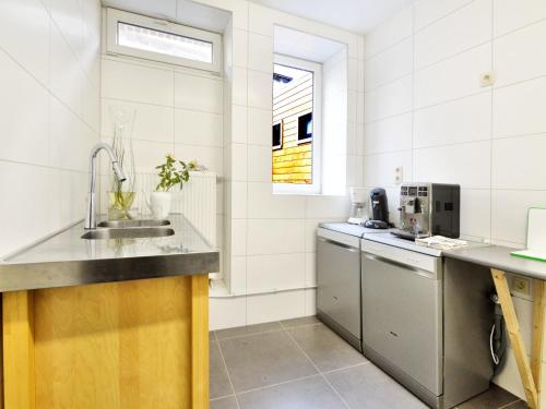 a kitchen with a sink and a counter at Walk Luxury Stay with Pool in Robertville