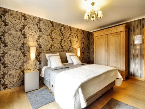 a bedroom with a bed and a wall with wallpaper at Walk Luxury Stay with Pool in Robertville