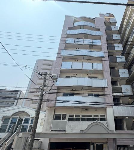 a tall apartment building with a lot of windows at N's Hotel 平和公園 in Hiroshima
