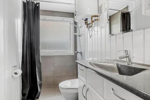 a white bathroom with a sink and a toilet at LF160-Vestervig-Gunhildsvej-60 in Vestervig