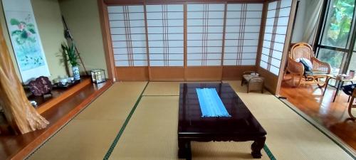 a living room with a table in the middle of it at Kanupata - Vacation STAY 18611 in Ishigaki Island