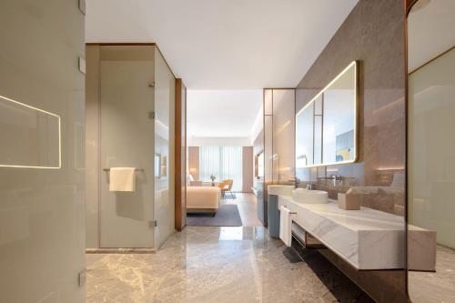 a bathroom with a sink and a mirror at voco Chengdu Chunxi Road by IHG in Chengdu