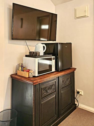 a microwave sitting on top of a wooden cabinet at Peaceful 1BR Escape Perfect Katoomba Leura Base in Katoomba