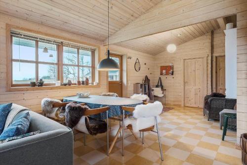 a living room with a table and chairs at LF10999-Thyholm-Ringvejen-9 in Thyholm