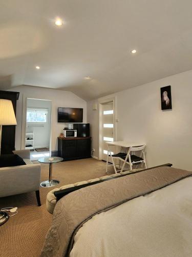 a bedroom with a bed and a living room with a couch at Peaceful 1BR Escape Perfect Katoomba Leura Base in Katoomba
