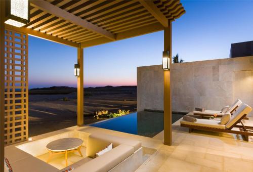 a living room with a couch and a table at Alila Hinu Bay Salalah Mirbat in Salalah