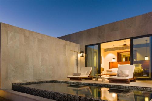 a villa with a swimming pool and a bedroom at Alila Hinu Bay Salalah Mirbat in Salalah