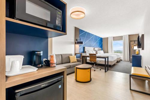 a living room with a couch and a bedroom at Comfort Inn & Suites at Sanford Sports Complex in Sioux Falls