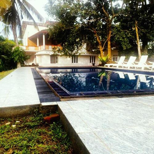 a person riding a skateboard in a swimming pool at DIS Herbal Villa in Induruwa