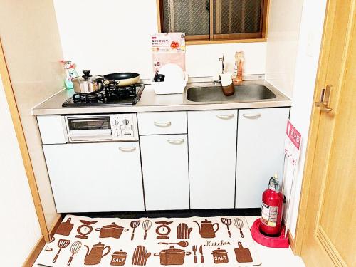 a kitchen with a kitchen floor covered in cookies at Sweet House Sugamo 101 in Tokyo