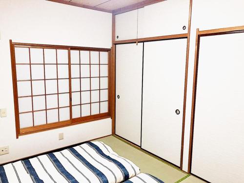 a room with two closets and a bed in it at Sweet House Sugamo 101 in Tokyo