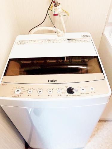 a microwave oven sitting on top of a wall at Sweet House Sugamo 101 in Tokyo