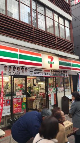 a group of people standing in front of a store at Sweet House Sugamo 101 in Tokyo
